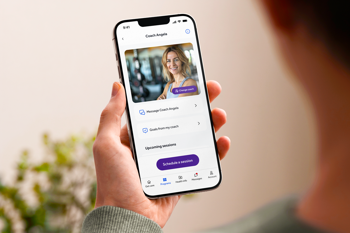 person holding iPhone showing the teladoc coaching center home page